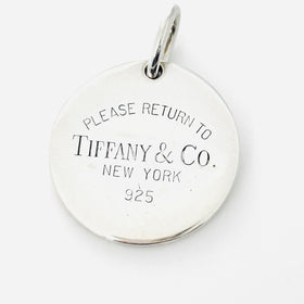 Return to Tiffany & Co Round Tag Pendant or Charm in 925 Sterling Silver