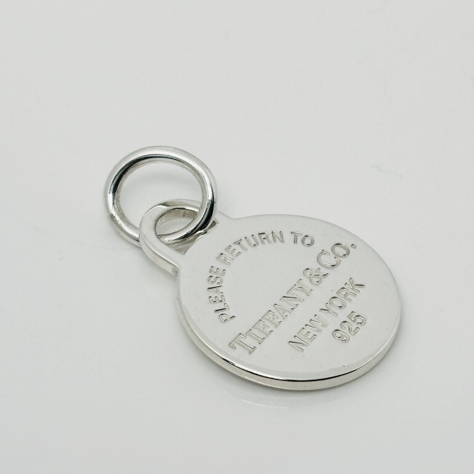 Please Return to Tiffany & Co Silver Round Tag Circle Charm or Pendant in Silver