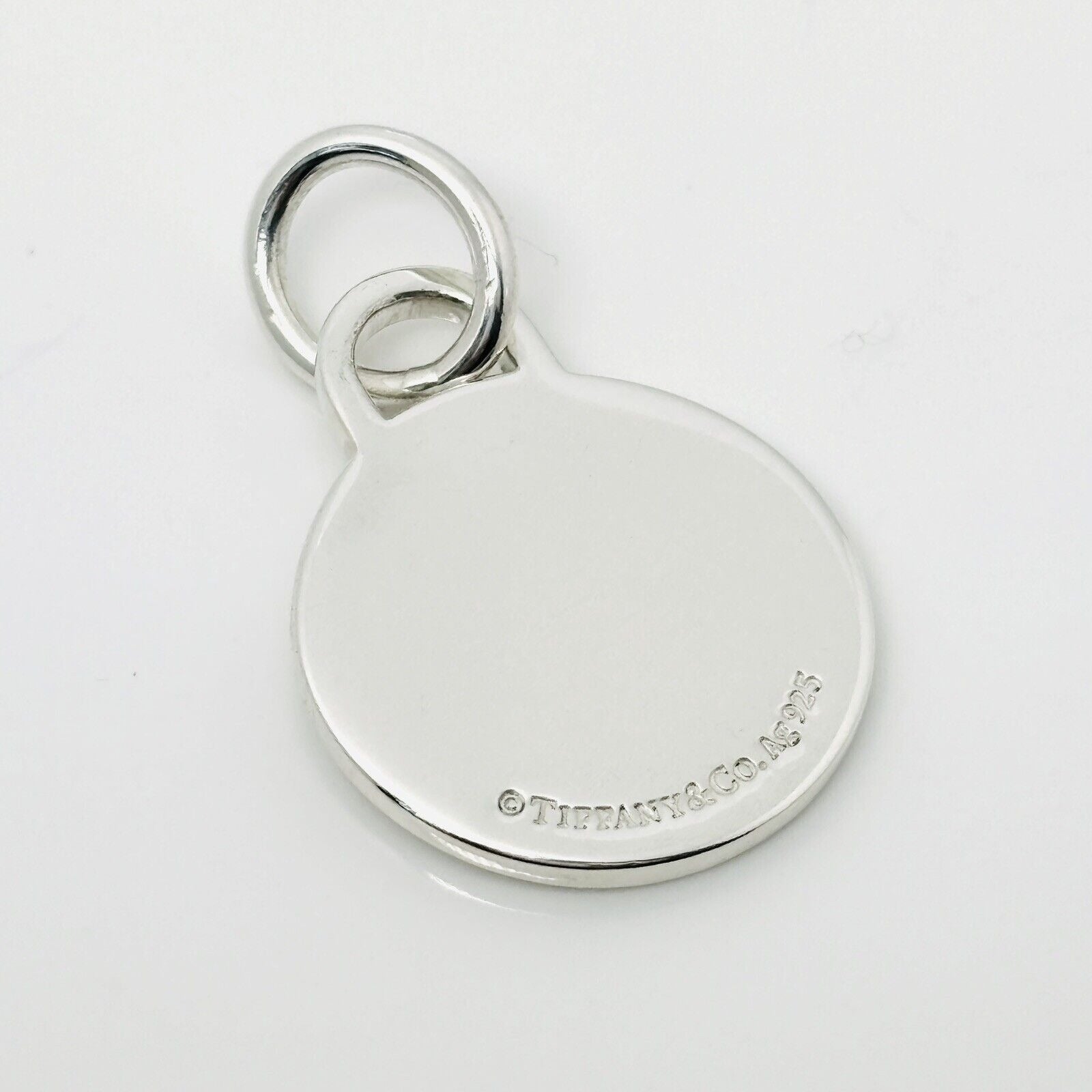 Please Return to Tiffany & Co Silver Round Tag Circle Charm or Pendant in Silver